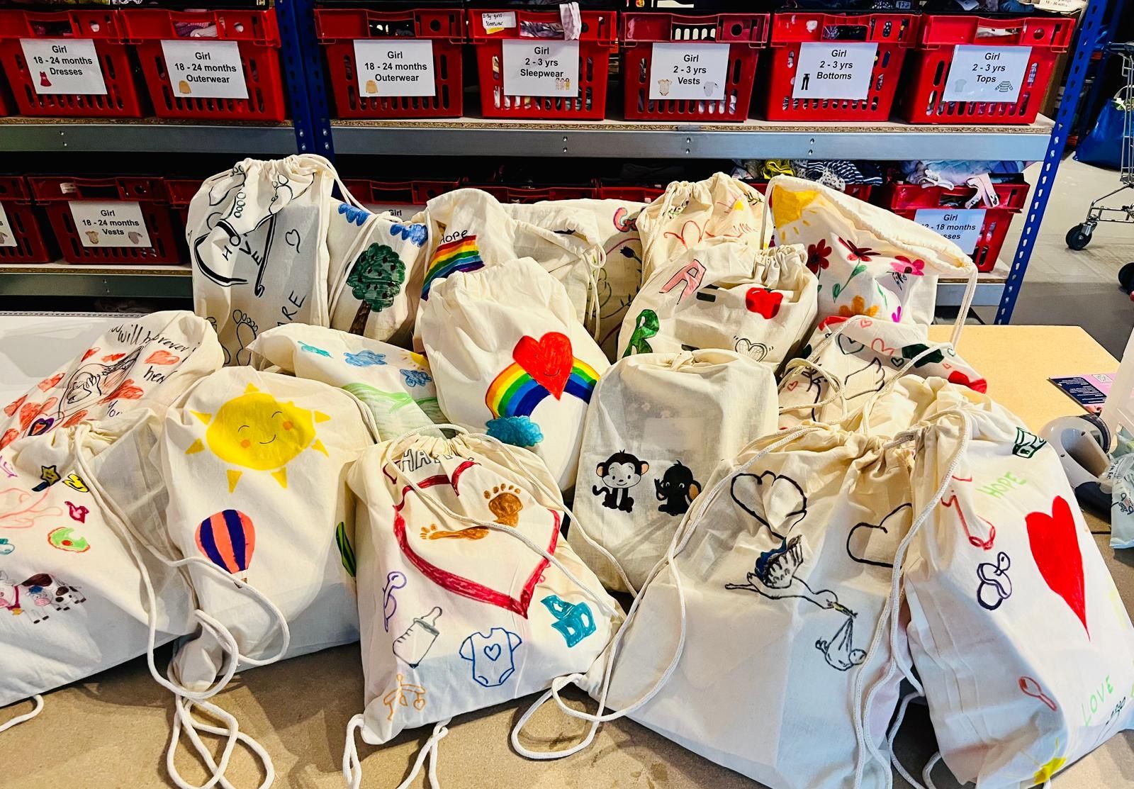 Hand-decorated drawstring bags prepared for children