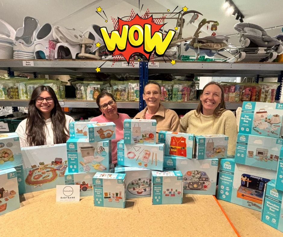Volunteers with stacks of new toys for children